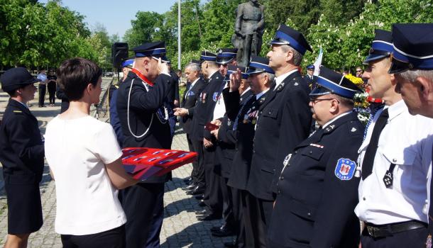 Sławomir Kowalewski i Leszek Ośliźlok dekorują strażaków medalami Zasłużony dla Miasta Mława