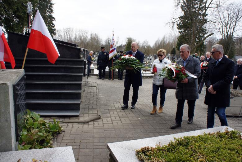 Wiązanki kwiatów i znicze składają Burmistrz Miasta Mława Sławomir Kowalewski, Radna Miasta Mława Zofia Kazimierska, Starosta Mławski Jerzy Rakowski i Przewodniczący Rady Powiatu Jan Łukasik