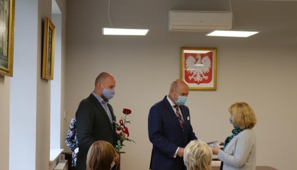 Burmistrz Sławomir Kowalewski i jego zastępca Szymon Zejer wręczają nagrodę nauczycielowi